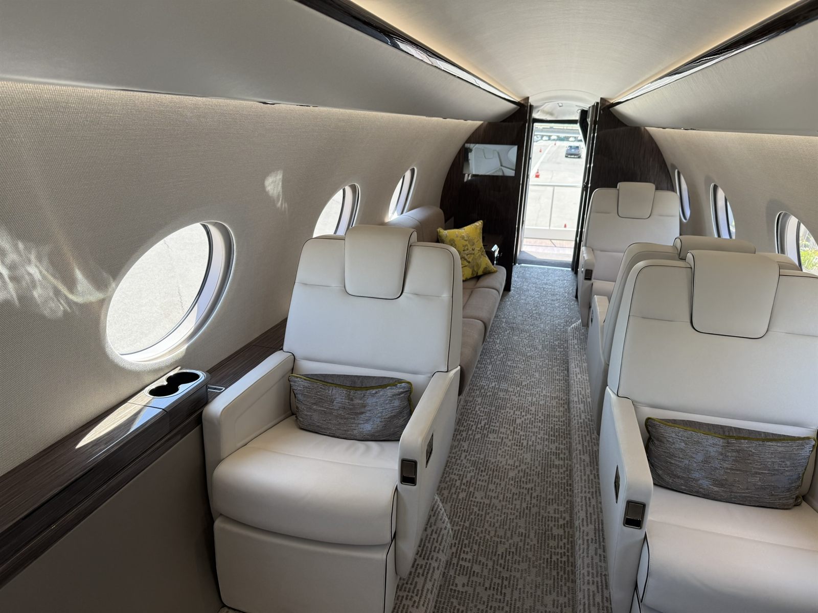 Super-midsize jet cabin with club seating and a forward sofa