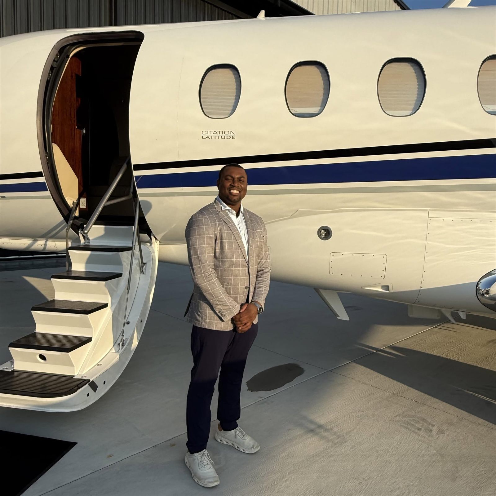 Cam beside a Citation Latitude at golden hour