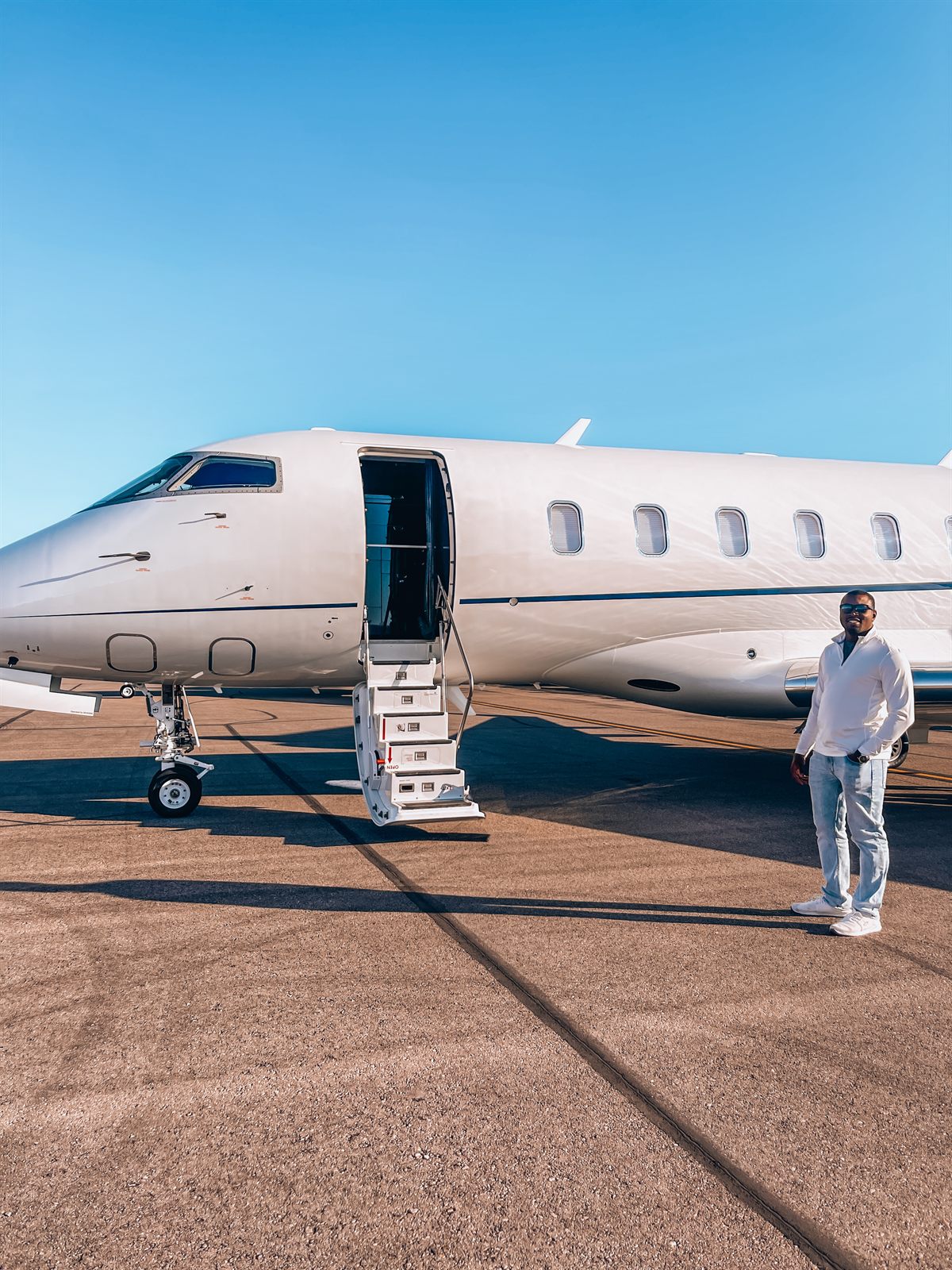 Cam on the ramp beside a super-midsize jet with the airstair down
