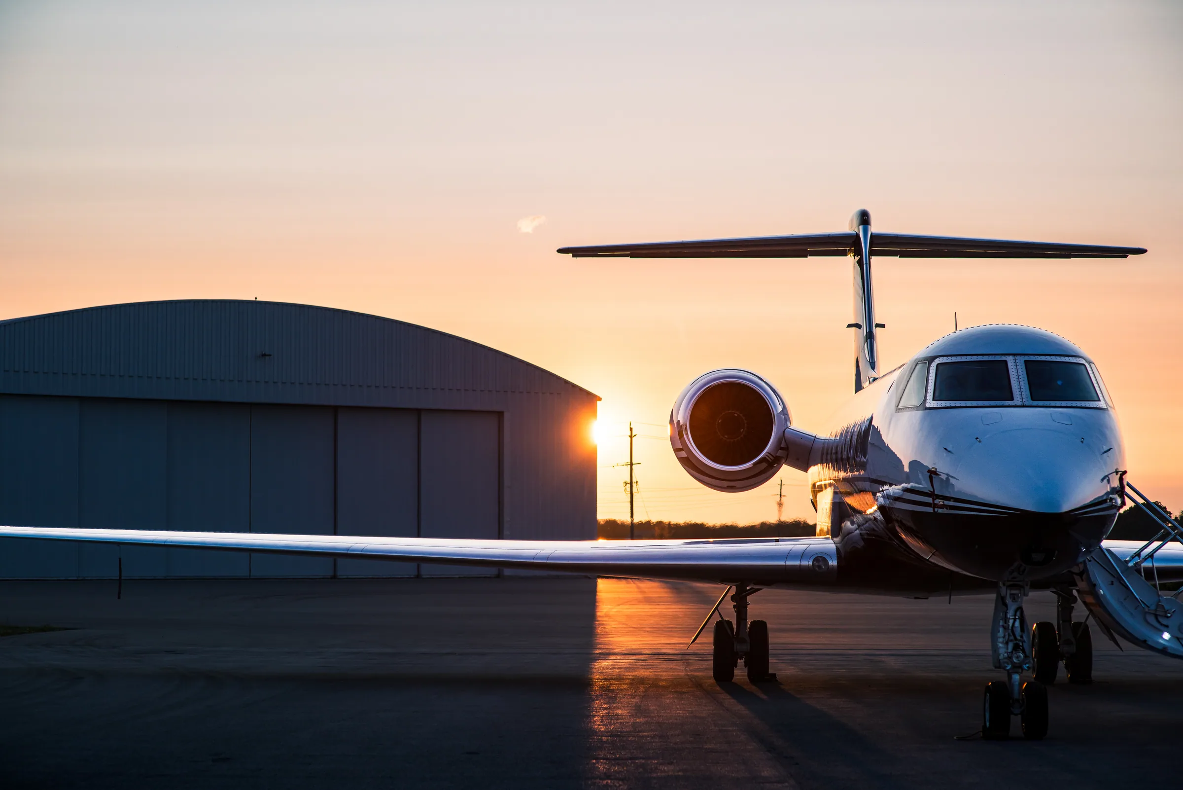 Private jet on the ramp at sunset