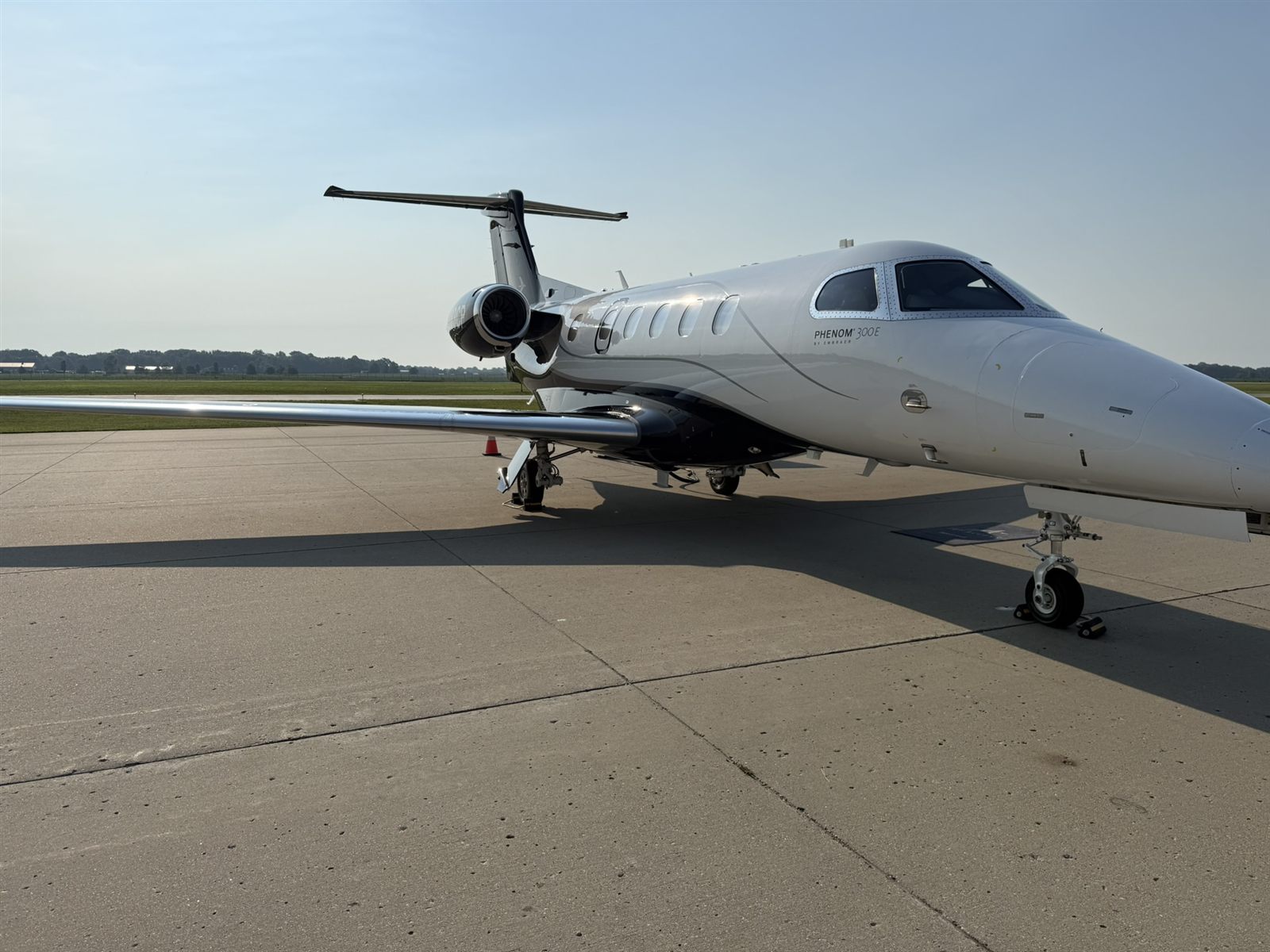 Phenom 300E on the ramp in morning light